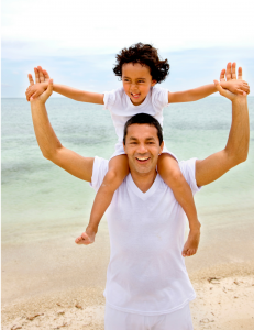 father holding son on shoulders