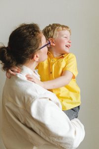 Higley Parenting Plan Lawyer woman carrying boy wearing yellow polo shirt 3905790 200x300